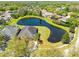 Gorgeous aerial view of the home and a large pond with lush landscaping at 19230 Wind Dancer St, Lutz, FL 33558