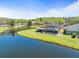 Gorgeous backyard with a large pond, mature trees and a screened-in lanai at 19230 Wind Dancer St, Lutz, FL 33558