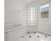 Beautiful bathroom boasts a large soaking tub and a shower with decorative glass block at 19230 Wind Dancer St, Lutz, FL 33558