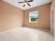 Neutral toned bedroom with tiled flooring and large window offering natural light at 19230 Wind Dancer St, Lutz, FL 33558