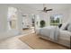 Bright primary bedroom with large windows, mirrored closets, and neutral decor at 19230 Wind Dancer St, Lutz, FL 33558