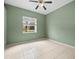 Bright bedroom with tiled floor, ceiling fan and a view of the yard at 19230 Wind Dancer St, Lutz, FL 33558