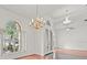Bright foyer with arched windows, chandelier, and stylish tile and wood flooring at 19230 Wind Dancer St, Lutz, FL 33558