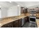 The kitchen features granite counters, dark cabinets, stainless appliances, and a breakfast bar at 19230 Wind Dancer St, Lutz, FL 33558