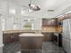 Well-equipped kitchen with dark wood cabinets, granite countertops, and stainless steel appliances at 19230 Wind Dancer St, Lutz, FL 33558