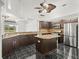 Modern kitchen with granite countertops, stainless steel appliances, and a center island at 19230 Wind Dancer St, Lutz, FL 33558