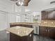 Stylish kitchen features a center island, granite countertops, and stainless steel appliances at 19230 Wind Dancer St, Lutz, FL 33558