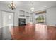 Open living room with hardwood floors, fireplace, and built-in shelving, perfect for entertaining at 19230 Wind Dancer St, Lutz, FL 33558