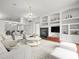 Open-concept living area features a fireplace, built-in shelving, and stylish furnishings in a bright space at 19230 Wind Dancer St, Lutz, FL 33558