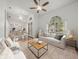 Bright, open living room with a large arched window and view to the dining area at 19230 Wind Dancer St, Lutz, FL 33558