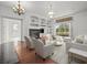 Bright living room featuring a fireplace, built-in shelves, and access to an outdoor pool area at 19230 Wind Dancer St, Lutz, FL 33558