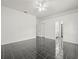 Spacious living room featuring tiled floors and access to bathroom in hallway at 19230 Wind Dancer St, Lutz, FL 33558
