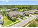 Aerial view showcasing a home with a screened pool, mature trees, and a well-manicured lawn at 19412 Lonesome Pine Dr, Land O Lakes, FL 34638