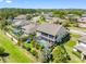 Aerial view showcasing a backyard with a screened pool, playground, and lush landscaping at 19412 Lonesome Pine Dr, Land O Lakes, FL 34638