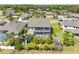 Aerial view of home featuring a screened-in pool, fenced yard, and mature landscaping at 19412 Lonesome Pine Dr, Land O Lakes, FL 34638