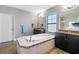 Modern bathroom featuring a soaking tub, dual vanities, and stylish fixtures at 19412 Lonesome Pine Dr, Land O Lakes, FL 34638