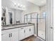 Modern bathroom boasts granite countertops, white cabinetry, a glass-enclosed shower, and ample natural light at 19412 Lonesome Pine Dr, Land O Lakes, FL 34638