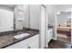 Bright bathroom featuring granite counters, modern fixtures and white cabinetry, complemented by wood-look flooring at 19412 Lonesome Pine Dr, Land O Lakes, FL 34638