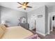 Neutral bedroom featuring modern furniture, a ceiling fan, plush carpeting, and a window for natural light at 19412 Lonesome Pine Dr, Land O Lakes, FL 34638