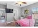 A princess themed bedroom with ensuite bathroom access, carriage bed and tv at 19412 Lonesome Pine Dr, Land O Lakes, FL 34638