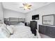 Neutral bedroom featuring a bunk bed setup, dresser, TV, ceiling fan, and soft carpeting, ideal for flexible living at 19412 Lonesome Pine Dr, Land O Lakes, FL 34638