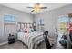 Cozy bedroom features neutral walls, multiple windows, and a ceiling fan at 19412 Lonesome Pine Dr, Land O Lakes, FL 34638