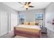 Bright bedroom featuring neutral walls, a ceiling fan, plush carpeting, and a large window for natural light at 19412 Lonesome Pine Dr, Land O Lakes, FL 34638