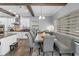 Open-concept kitchen with a dining area featuring a wooden table, cushioned seating, and wood-look flooring at 19412 Lonesome Pine Dr, Land O Lakes, FL 34638