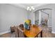 Dining area with stylish wood table, wicker chairs, decorative lighting, and an open view of the staircase at 19412 Lonesome Pine Dr, Land O Lakes, FL 34638