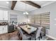 Open dining area boasts a long table with booth and chair seating, complemented by soft, natural light at 19412 Lonesome Pine Dr, Land O Lakes, FL 34638