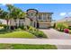 Beautiful two-story home with stone accents, balcony, manicured lawn, and mature landscaping at 19412 Lonesome Pine Dr, Land O Lakes, FL 34638
