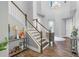 Welcoming foyer with staircase, high ceilings, decorative chandelier, wood-look flooring, and light gray walls at 19412 Lonesome Pine Dr, Land O Lakes, FL 34638