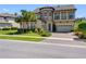 Lovely two-story home with stone tower, balcony, lush lawn, and paver driveway at 19412 Lonesome Pine Dr, Land O Lakes, FL 34638