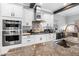 Gourmet kitchen features stainless steel appliances, granite countertops, and an open layout perfect for entertaining at 19412 Lonesome Pine Dr, Land O Lakes, FL 34638