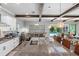 Spacious kitchen island featuring a sink, granite countertops, and pendant lighting with views to the backyard at 19412 Lonesome Pine Dr, Land O Lakes, FL 34638