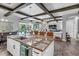 Stylish kitchen island boasting granite counters, a sink, and seating with views of the pool and living area at 19412 Lonesome Pine Dr, Land O Lakes, FL 34638