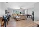 Spacious living room featuring modern furniture, hardwood flooring, a ceiling fan, and a pool table at 19412 Lonesome Pine Dr, Land O Lakes, FL 34638