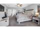 Main bedroom featuring neutral walls, a ceiling fan, plush carpeting, and a large window for natural light at 19412 Lonesome Pine Dr, Land O Lakes, FL 34638