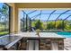 Outdoor kitchen with stainless steel grill, mini fridge, and ample counter space at 19412 Lonesome Pine Dr, Land O Lakes, FL 34638