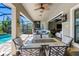 Spacious outdoor patio with comfortable seating, dining area, and outdoor television at 19412 Lonesome Pine Dr, Land O Lakes, FL 34638