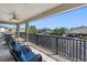 Spacious, screened patio with wrought iron railing, ceiling fan and comfortable furniture at 19412 Lonesome Pine Dr, Land O Lakes, FL 34638