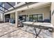 Expansive covered patio with a stone bar, grill, and ample seating, perfect for outdoor entertaining at 19412 Lonesome Pine Dr, Land O Lakes, FL 34638