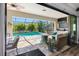 Inviting covered patio with outdoor seating, a mounted television, and views of the sparkling pool at 19412 Lonesome Pine Dr, Land O Lakes, FL 34638