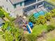 A backyard complete with playset, screened in pool, lush landscaping and mature trees at 19412 Lonesome Pine Dr, Land O Lakes, FL 34638