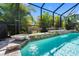 Beautiful pool featuring stone accents, planter boxes, and tranquil waterfalls at 19412 Lonesome Pine Dr, Land O Lakes, FL 34638