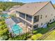 Backyard featuring a screened in pool, large lanai, lush landscaping and mature trees at 19412 Lonesome Pine Dr, Land O Lakes, FL 34638