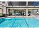 Beautiful backyard pool with outdoor kitchen, patio seating, and screened-in enclosure at 19412 Lonesome Pine Dr, Land O Lakes, FL 34638