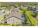 A beautiful home with a screened in pool, lush green grass, mature trees and a play set at 19412 Lonesome Pine Dr, Land O Lakes, FL 34638