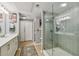 This bathroom features bright lighting, a glass shower, and a modern sink and vanity at 2010 E Palm Ave # 15210, Tampa, FL 33605
