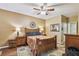 This bedroom features hardwood floors, a ceiling fan and an eye-catching accent rug at 2010 E Palm Ave # 15210, Tampa, FL 33605